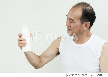 Asian senior man holding bottle of milk. 29959833