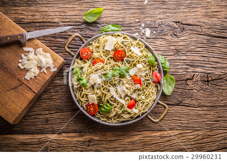 Italian spaghetti with basil pesto and tomatoes. 29960231