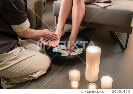 Hands of an Asian therapist during foot washing Hands of an Asian therapist during foot washing 29961490
