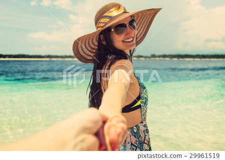 Woman wanting her man to follow her in vacation Woman wanting her man to follow her in vacation 29961519