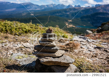 Stone pyramid marking hiking path in the mountains Stone pyramid marking hiking path in the mountains 29961521