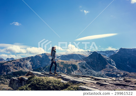 Woman admiring the view hiking the rila mountains Woman admiring the view hiking the rila mountains 29961522