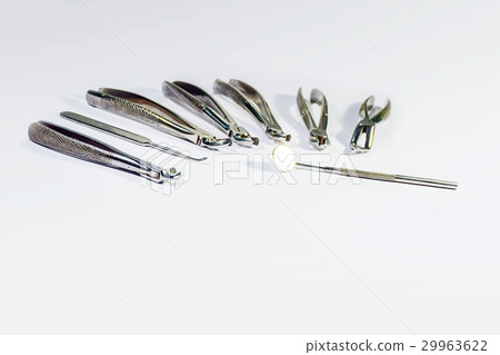 Dental Instruments arranged on white table. Dental Instruments arranged on white table. 29963622