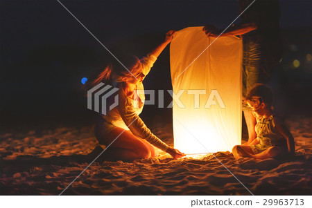 Family send air heavenly flashlight lamp in flight on beach 29963713