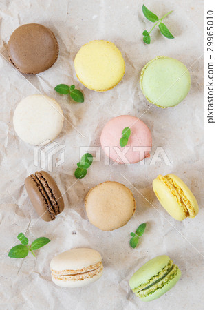 Multicoloured macaroons and mint leaves Multicoloured macaroons and mint leaves 29965010