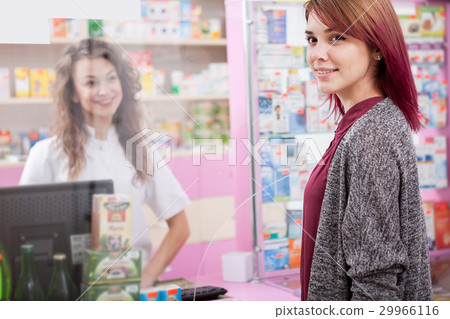 Pharmacist and her client in front of the desk Pharmacist and her client in front of the desk 29966116