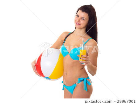 Woman in swimming suit holding cocktail and ball Woman in swimming suit holding cocktail and ball 29967001