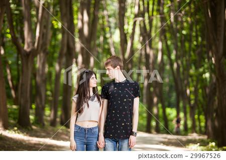 Beautiful couple taking a walk in the forest 29967526