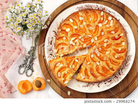 Apricot tart and bouquet of daisies Apricot tart and bouquet of daisies 29968274