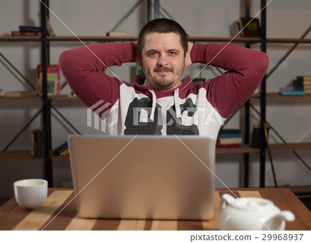 Man with laptop leans back  29968937