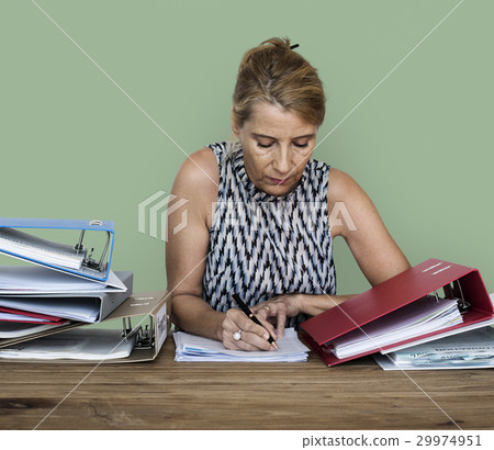 An office worker woman working on a lot of files An office worker woman working on a lot of files 29974951