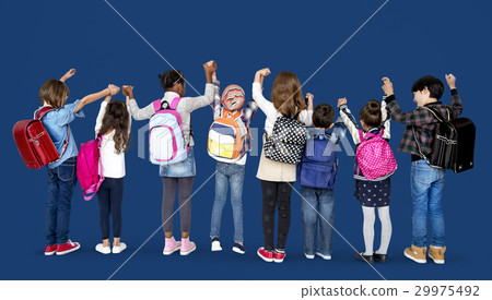 Rear view group of diverse kids standing in a row holdings hands in the air Rear view group of diverse kids standing in a row holdings hands in the air 29975492
