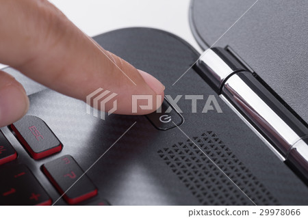 finger pushing power button on laptop keyboard 29978066