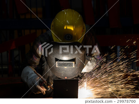 Worker with protective mask welding metal Worker with protective mask welding metal 29978700