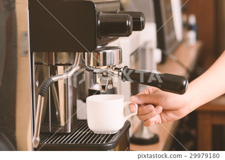 Barista making coffee from espresso machine Barista making coffee from espresso machine 29979180