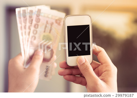 Hand holding smartphone to paying Hand holding smartphone to paying 29979187