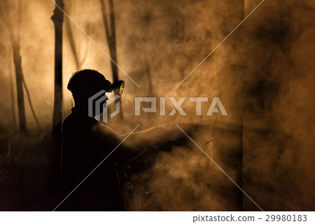 Man Tapping Rubber Tree at Night 29980183