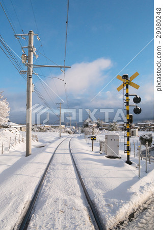 Railway track for local train with white snow fall 29980248