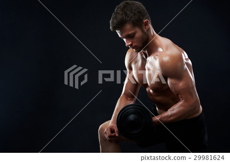 Muscular young man lifting weights on black 29981624