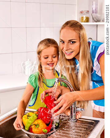 Fruit and vegetable wash of woman on kitchen home. Fruit and vegetable wash of woman on kitchen home. 29982101