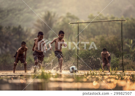 Boy kicking a soccer ball 29982507