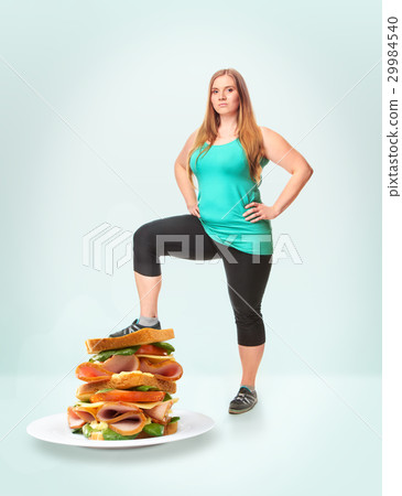Unhealthy food and fat woman 29984540