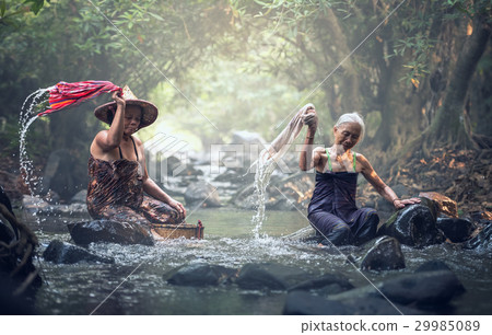 Asian old women washing clothes at the creek 29985089
