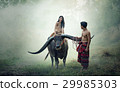 Couple farmer in farmer suit with buffalo on field 29985303