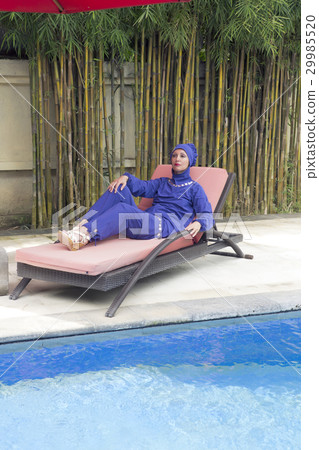 attractive woman in a Muslim swimwear burkini on a attractive woman in a Muslim swimwear burkini on a 29985520