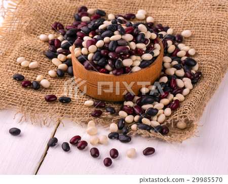 Colored haricot beans in a wooden cup Colored haricot beans in a wooden cup 29985570