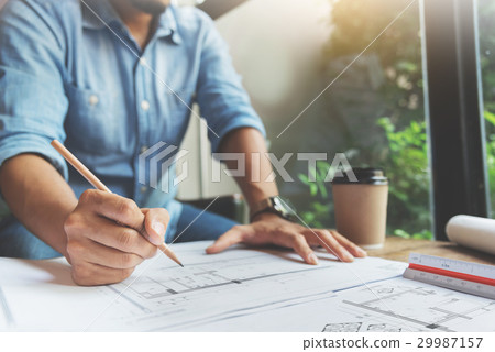 man writing on document papers with pencil.  29987157