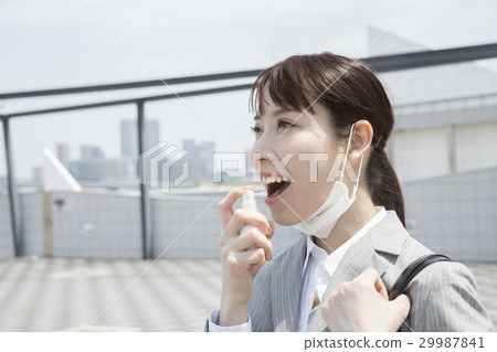 Business woman spraying throat 29987841