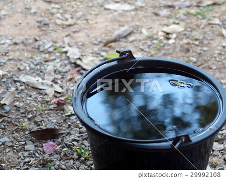 black plastic bucket on the floor outdoor black plastic bucket on the floor outdoor 29992108