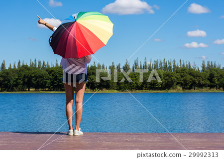 Woman holding an umbrella. Woman holding an umbrella. 29992313
