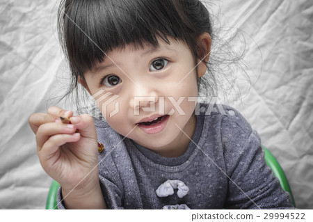 Cute little Asian Girl Holding Pencil in Hand. 29994522