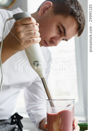 Young male preparing smoothie 29995185