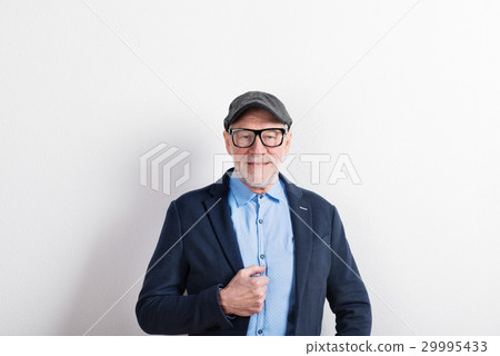 Senior man in blue shirt, jacket, eyeglasses and 29995433