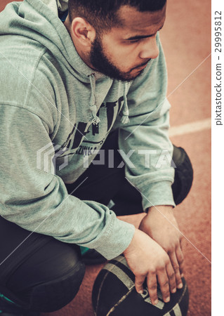 African-american streetball player resting. 29995812