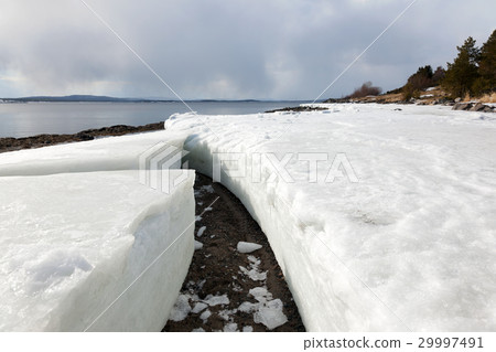 Lumps of ice on the shore of the northern sea 29997491