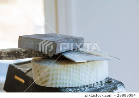 Painting worker puttied wall using spatula hand. Painting worker puttied wall using spatula hand. 29999094