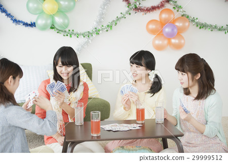 Four women playing cards 29999512