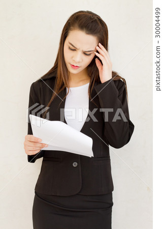 frustrated business woman reading the document 30004499