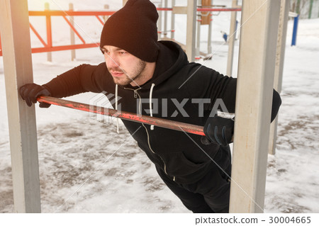 Young man wearing sportswear exercising outdoors 30004665