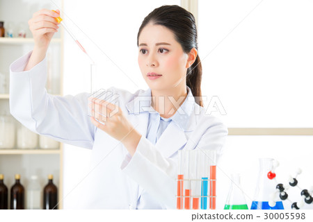 Careful, meticulous work of asian female scientist 30005598