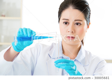 asian chemist mixing chemical substances 30005681