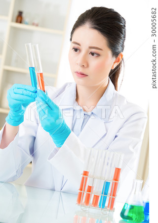 female forensic scientist working on chemicals 30005682