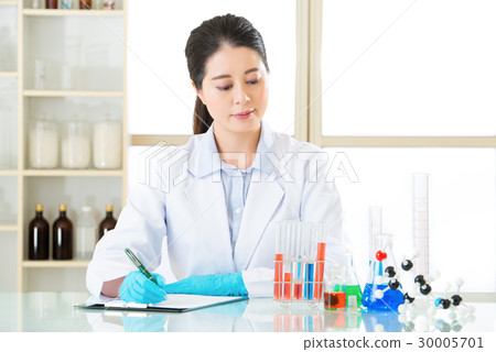 Asian female scientist Recording her data 30005701