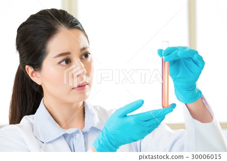 Beautiful biologist pipetting in life science 30006015