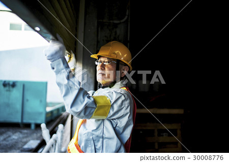 Worker opening the construction site shutter Worker opening the construction site shutter 30008776