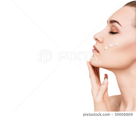 Beautiful woman with cream drops on cheek. 30008809